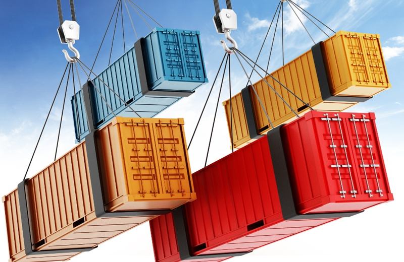 Colourful shipping containers being lifted by crane slings